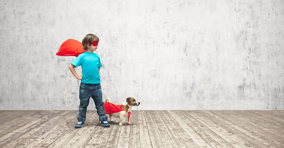 A young boy and his jack russell puppy stand side by side looking stage right. They are both wearing red caps that are flying behind them. The boy is also wearing a red mask. All to help promote the /2018/03/count-down-to-puppy-part-1-of-3/ series